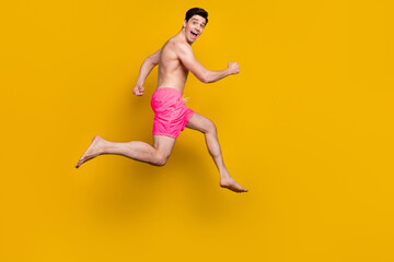 Fototapeta na wymiar Full length profile side photo of young man happy positive smile go walk run jumper isolated over yellow color background