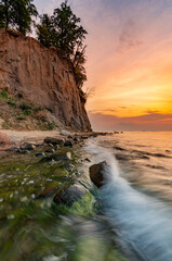 Baltic sea coast, beach and cliffs at Gdynia Orlowo during sunrise, Poland