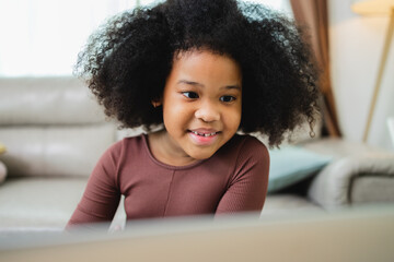 African American girl have fun working together while studying online using computers at home.