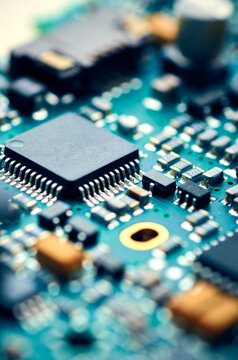 Electronic board with details and microchips, high-tech close-up, soft focus