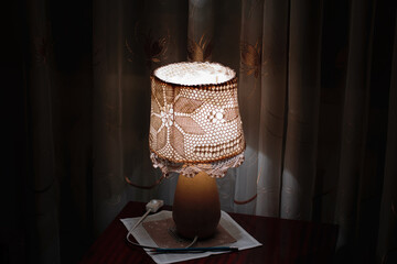 retro vintage lamp light creating cozy atmosphere shining on wooden table in living room on dark night
