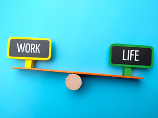 Wooden board with text WORK LIFE on blue background.