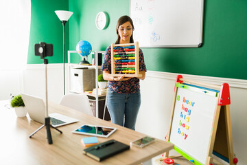 Beautiful teacher teaching the numbers