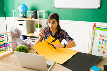 Female teacher doing crafts for preschool kids