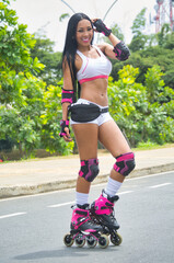 Latina woman skating in the street. With protection on elbows and knees