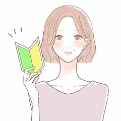 初心者マークを持つ中年女性