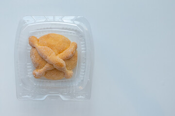 A Traditional Mexican day of the dead bread on a plastic container