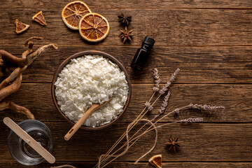 Set for crafting candle on wooden background. Eco soy wax on white table. DIY candle. Hobby concept.