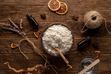 Set for crafting candle on wooden background. Eco soy wax on white table. DIY candle. Hobby concept.