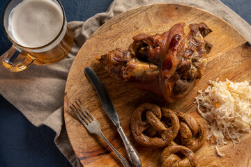 Roasted pork, beer and pretzels. Pork knuckle. Traditional Oktoberfest meal.