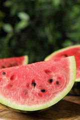 Delicious fresh watermelon slices on wooden table, closeup