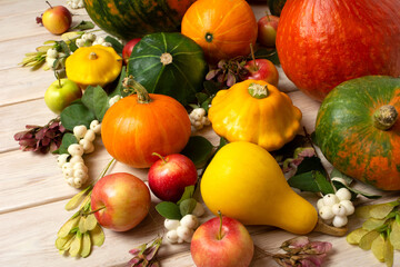 Fall arrangement with pumpkins, yellow, green squashes and gourds