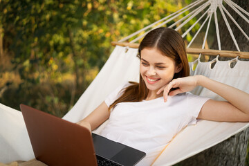Fototapeta na wymiar woman love with laptop on nature vacation work travel