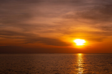 Naklejka na ściany i meble Sunset on the horizon, orange-red sea, nature at twilight, beautiful.