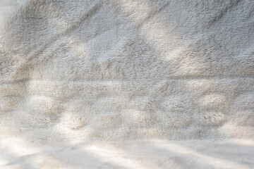White wool texture with close-up sunlight shadow used for beautiful pattern abstract fur background design.