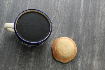 Freshly made Ojo de Pancha or Ox bread from Mexican cuisine in a basket, or napkin accompanied by coffee
