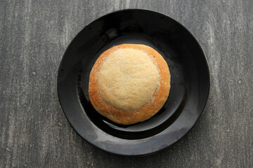 Freshly made Ojo de Pancha or Ox bread from Mexican cuisine in a basket, or napkin accompanied by coffee
