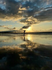 boy jumping at sunset in the beach 