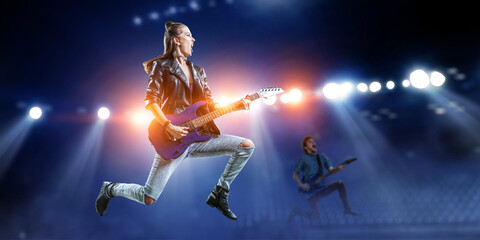 Fototapeta na wymiar Young and beautiful rock girl playing the electric guitar . Mixed media