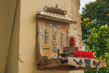 An old traditional Malaysian Chinese worshipping shrine of Tian Gong (God of heaven) set infront of a colonial style heritage shophouse in Kuala Kubu Bahru Selangor Malaysia  under a sunny cloudy day.