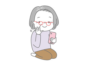 スマートフォンでビデオ通話しながら手を振っているおばあさん