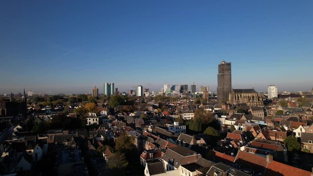 Lepelenburg park with the cityscape of Utrecht in the background where the scaffolded church tower rises above the urban Dutch city and financial district modern central train station behind