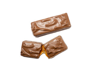 Broken chocolate bar and whole bar on a white background. Slices of chocolate.