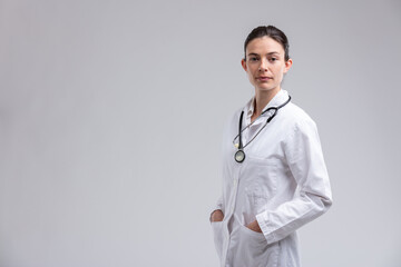Serious young woman doctor or nurse wearing a stethoscope