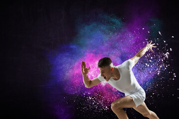 Naklejka na ściany i meble Portrait of a fitness man running on a colourful background