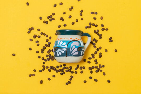 top view of traditional cup of Mexican coffee on organic coffee beans