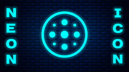 Glowing neon Sewing button for clothes icon isolated on brick wall background. Clothing button. Vector