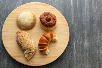 Sweet bread: Bisquet, croissant, Ojo de Pancha and Gusano freshly made from Mexican cuisine in a basket, or napkin accompanied by coffee
