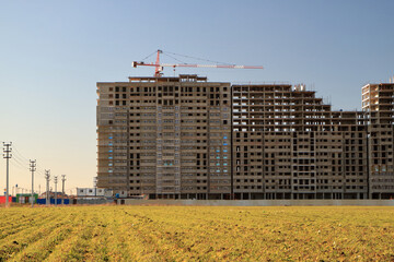 Tower cranes are working on the construction of a new house. Lifting crane.