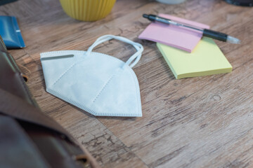 close up to face masks on bright desk. Protection against coronavirus, flu and other airborne infection. Copy space