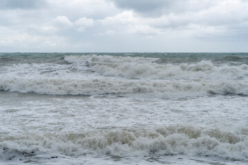storm on the black sea, waves crashing on the shore, brown water