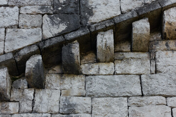 A stone parapet with the protrusions of the old tower rises.