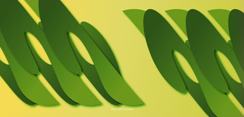 Green abstract shape isolated on a yellow background, looks like a plant in the afternoon.