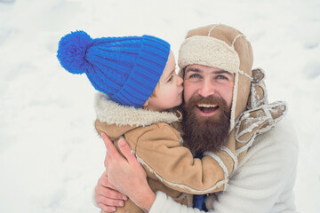Winter, father and son play outdoor. Daddy and boy kissing and hugging. The morning before...