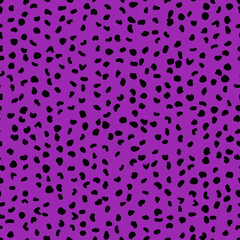 Abstract seamless pattern from small shapes. Simple background of irregular spots. Abstract wild animal skin print. Random spaced black spots. Vector illustration on purple background