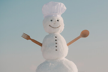 Snowman chef in winter with kitchen spoon. Christmas food cooking. Xmas or christmas cooking.