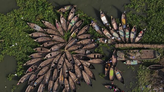 Aerial descends to an array of traditional Ghat wooden boats - Bangladesh