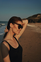 Naklejka premium cheerful woman sunglasses posing black swimsuit island