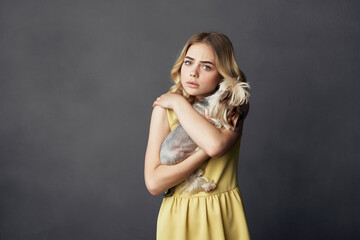 Fototapeta premium woman a small dog pet fun cropped view fashion
