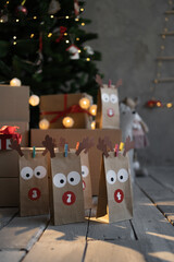 gifts and homemade advent calendar craft packages, stand under the tree, christmas background with...