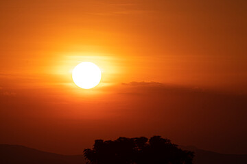 Beautiful sunset sky above clouds.  orange sunset sky. Beautiful sky.Dramatic red yellow sunset over the forest