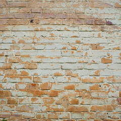 brick wall facade texture texture background. A textured background of decayed old red and white bricks in an exterior uneven wall of a house with dirty whitewashed worn plaster. Brick wall