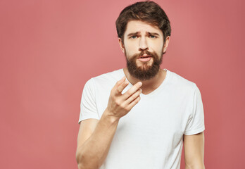 emotional man in a white t-shirt irritated facial expression Studio