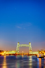 Fototapeta na wymiar Holland Destinations. Illuminated Koninginnebrug Bridge in Rotterdam During Blue Hour.