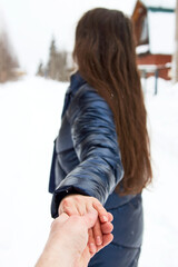 Beautiful woman in a winter forest enjoying first snow, outdoor
