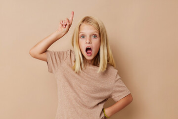 Positive little girl in a beige t-shirt lifestyle concept